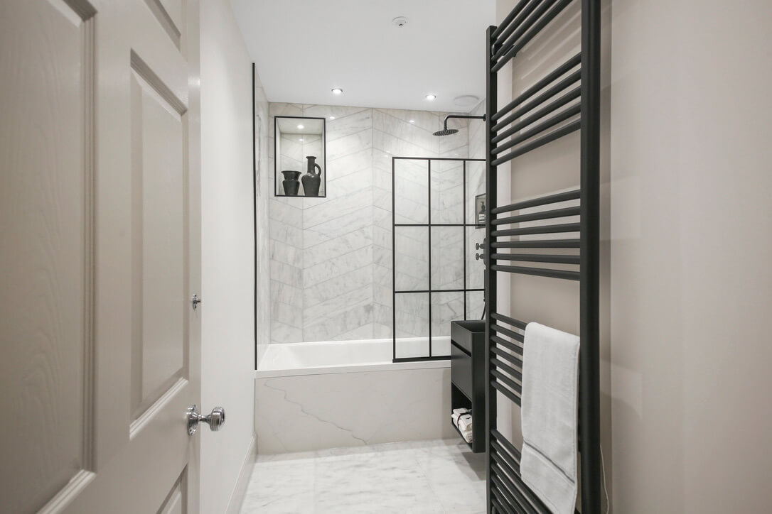 Monochrome bathroom with column towel radiator